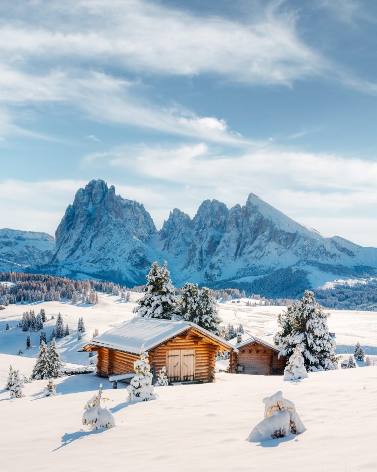 Picturesque landscape with small wooden house on meadow Alpe di Siusi