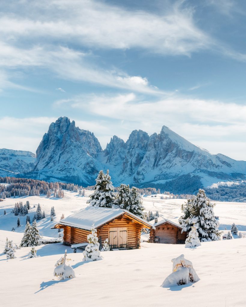 Picturesque landscape with small wooden house on meadow Alpe di Siusi