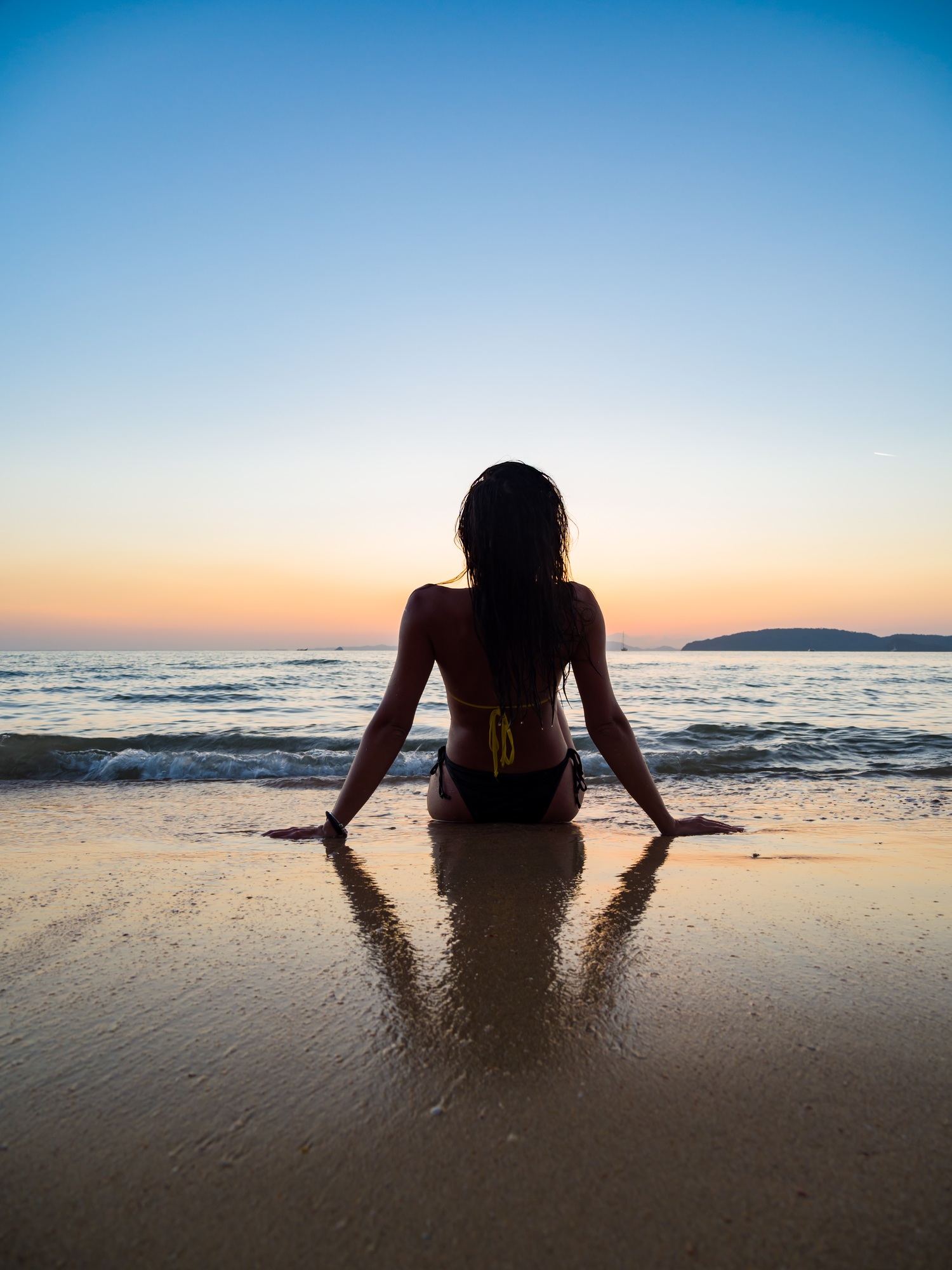 Silhouette of a woman on the beach at sunset