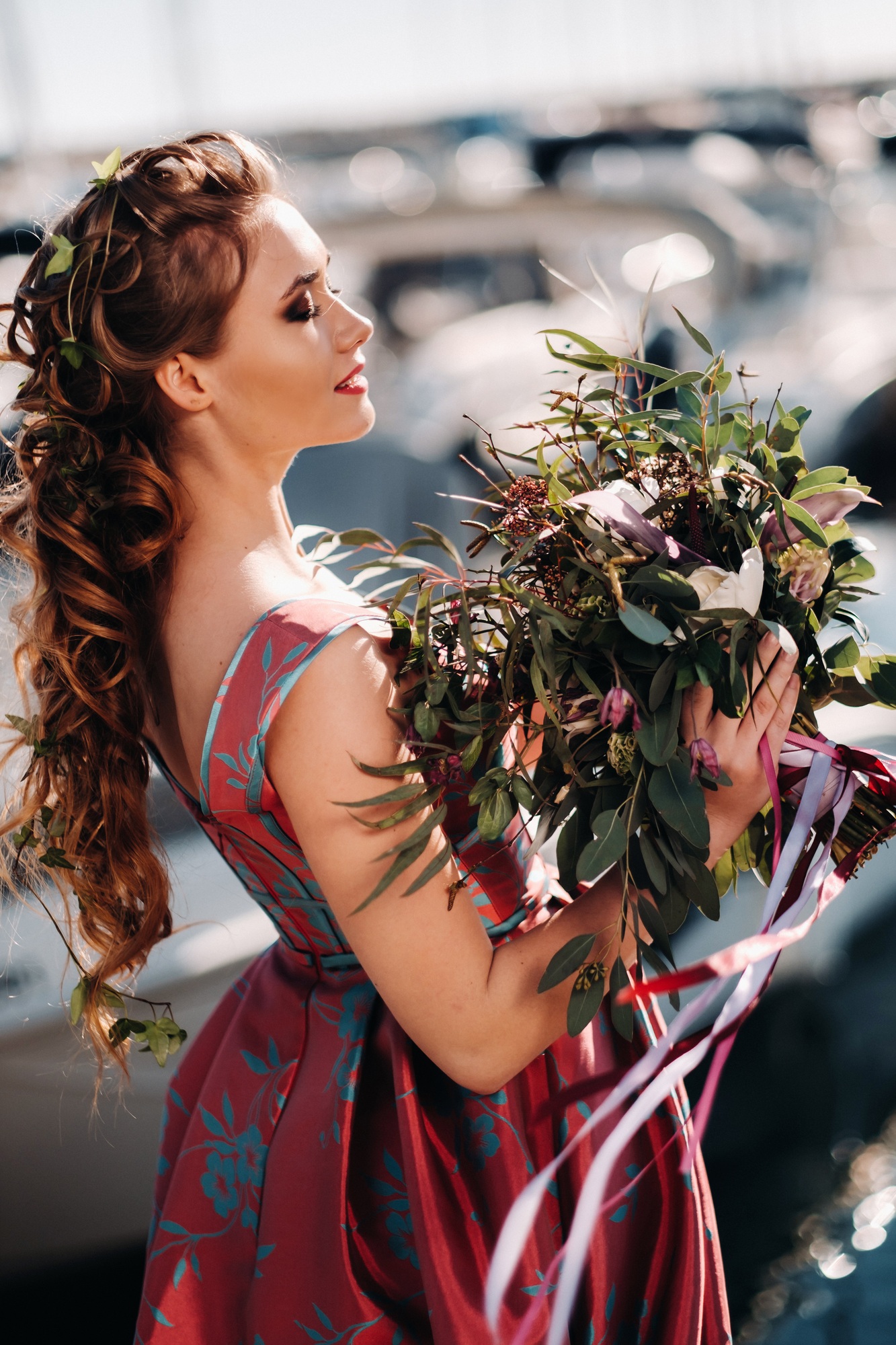 Young model girl in a beautiful dress with a bouquet of flowers on the beach in France. Girl with